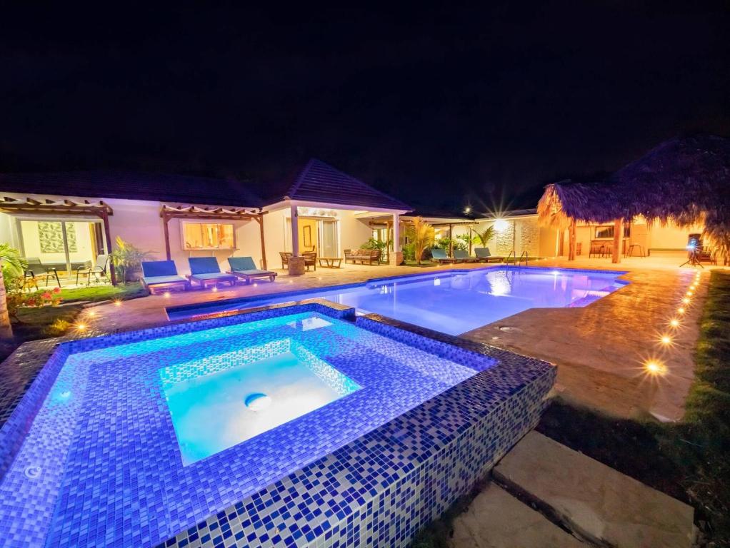 a swimming pool in a yard at night at Sun Soul - Caribbean 9br Villa In Sosua in Sosúa