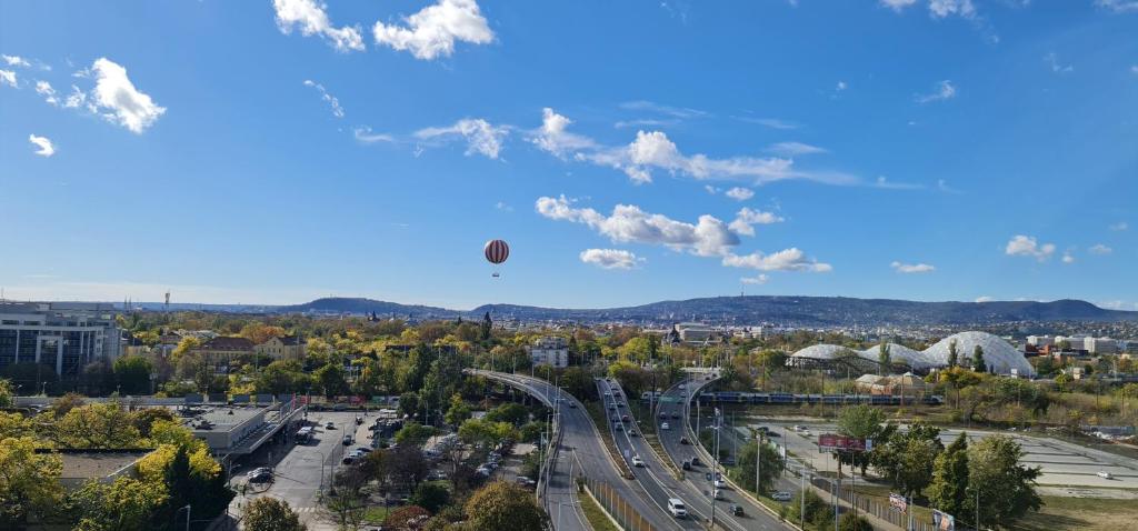 a hot air balloon in the sky over a city at Rooftop Panorama Apartment in Budapest