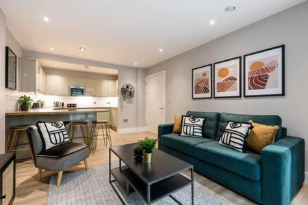 Host & Stay - Henry Street Chambers في ليفربول: غرفة معيشة مع أريكة زرقاء ومطبخ