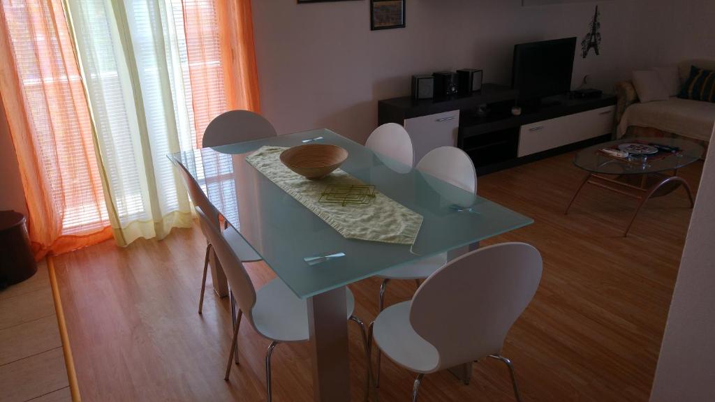 a glass table and chairs in a living room at Filip Apartment in Zadar