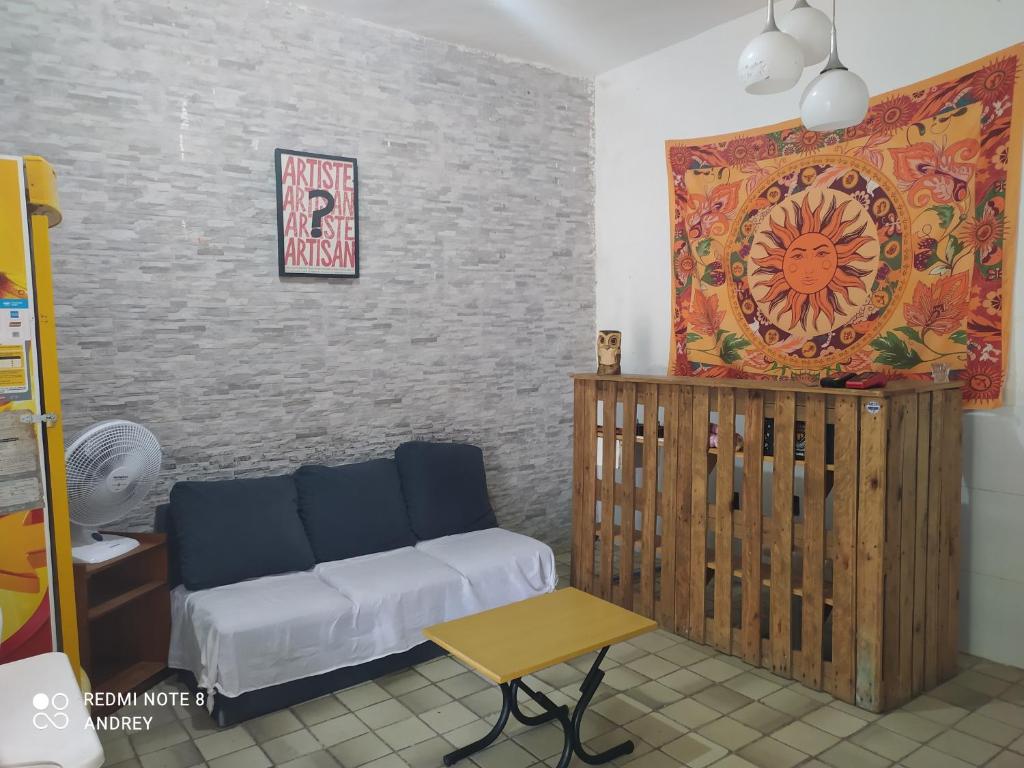 a living room with a couch and a table at Marbelo Pernambuco Hostel in Recife