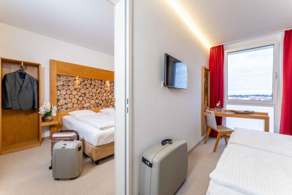 Postel nebo postele na pokoji v ubytování PLAZA INN Dachau - München