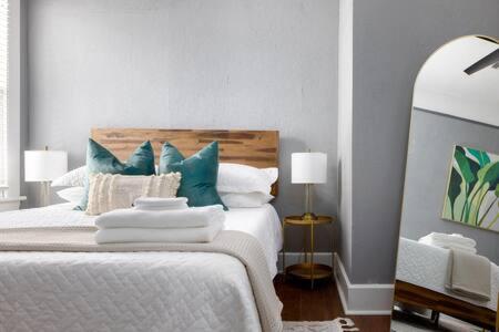 a bedroom with a white bed with blue pillows at Downtown, Updated, Single Story & WD in Columbus