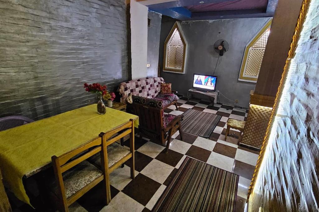 a living room with a table and a couch at Comfy Hostel-Style Home Near Pyramids in Cairo