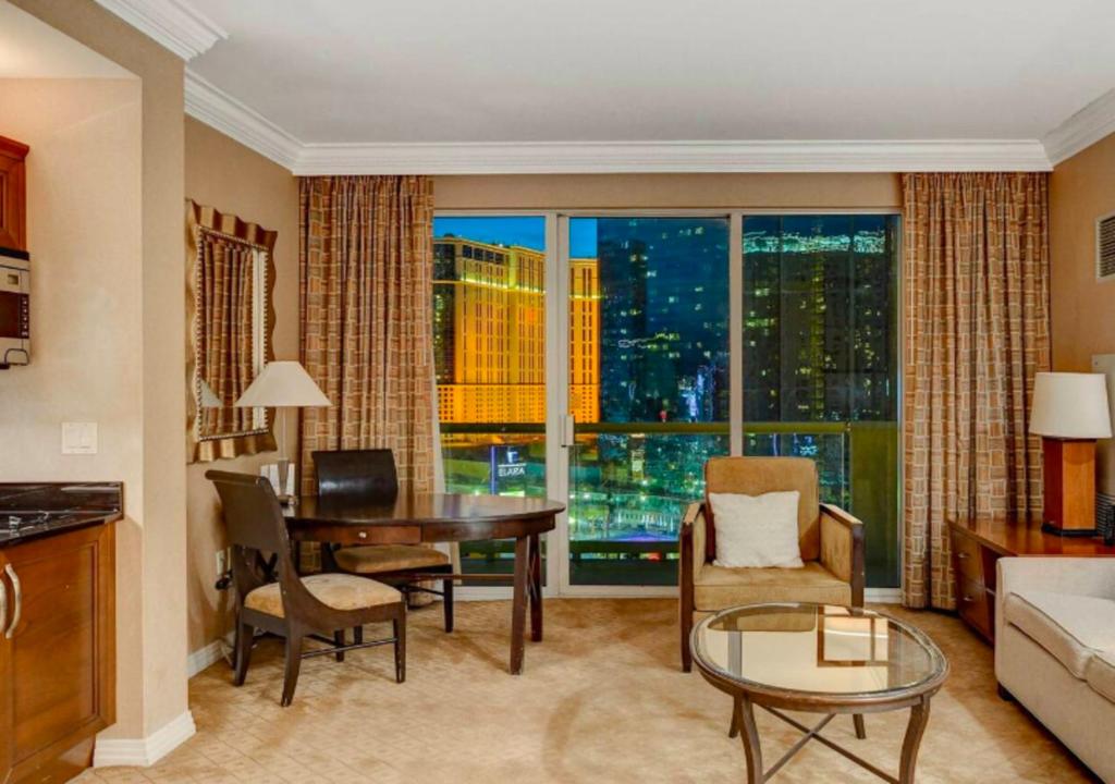 a living room with a table and a large window at Luxury Studio With Balcony At Las Vegas in Las Vegas