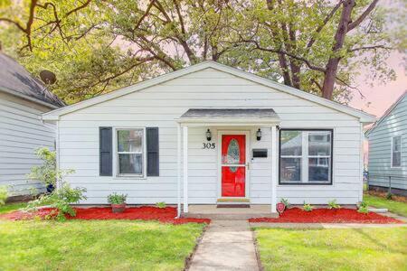 a small white house with a red door at Close to Beach, W&D, Pet friendly, Dunes, Casino in Michigan City