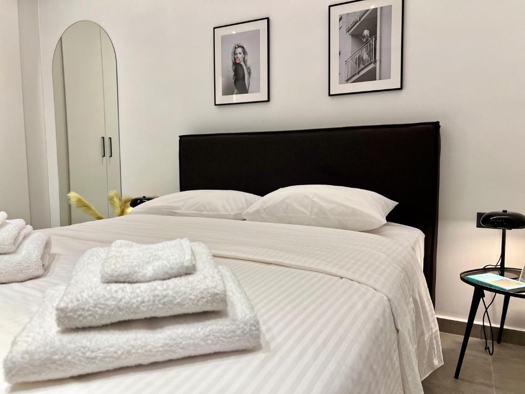 a bedroom with a white bed with two towels on it at Alice, 2-4 people, renovated stylish apartment in Athens
