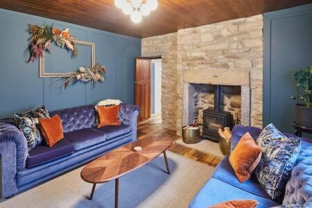 a living room with a couch and a fireplace at Host & Stay - Hecklers Cottage, Barnard Castle in Barnard Castle