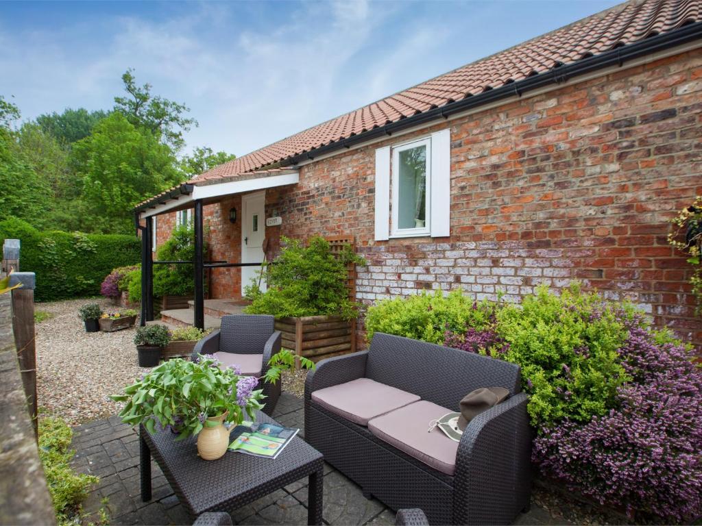 a patio with two chairs and a table at 2 Bed in Howden G0113 in Saltmarshe