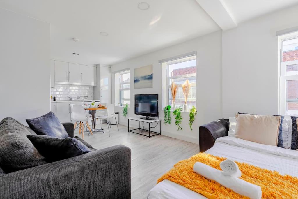 a living room with a couch and a tv at #7 six sleeps Zone1 - BrickLane in London