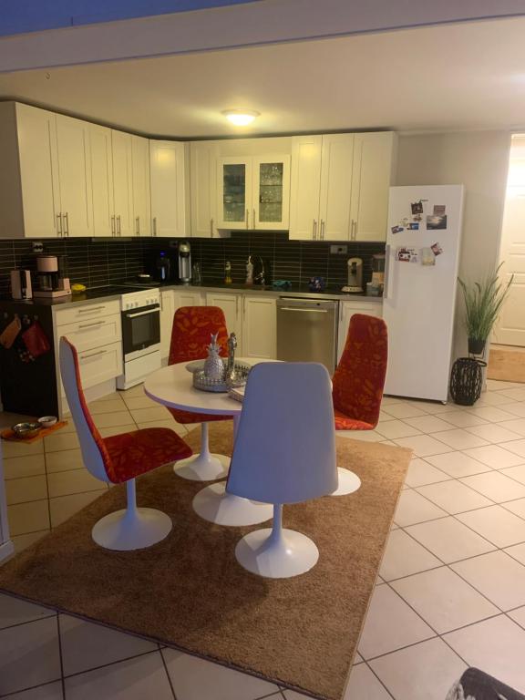 a kitchen with a table and chairs and a refrigerator at Tromsø in Tromsø