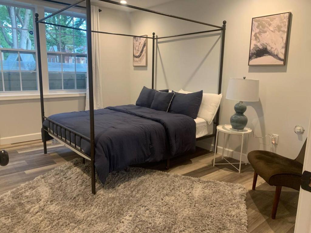 a bedroom with a canopy bed and a couch at Silver Spring Serene 2BR2BA, Nature And Access in Silver Spring