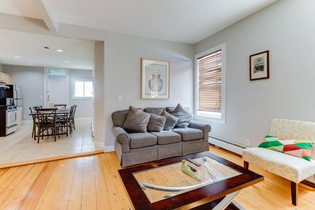 a living room with a couch and a table at NEW! Boston Condo Near MBTA, 3Mi to Fenway ! (U3) in Boston