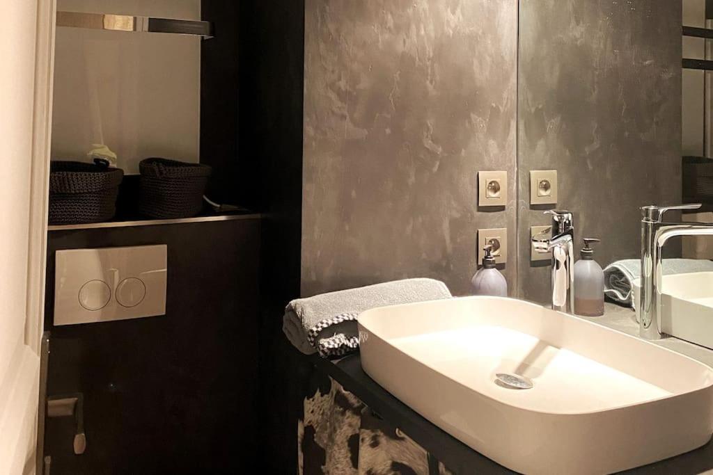 a bathroom with a white sink and a mirror at Family cocoon Prime Rochebrune location in Megève