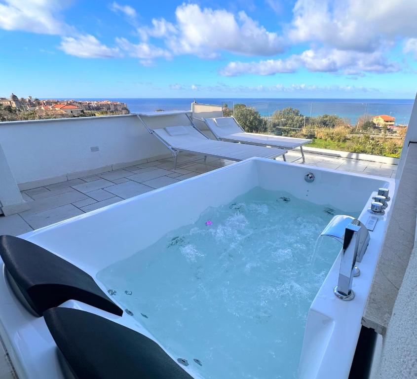 a jacuzzi tub with a view of the ocean at Aurantia - Mediterranean Tale in Tropea