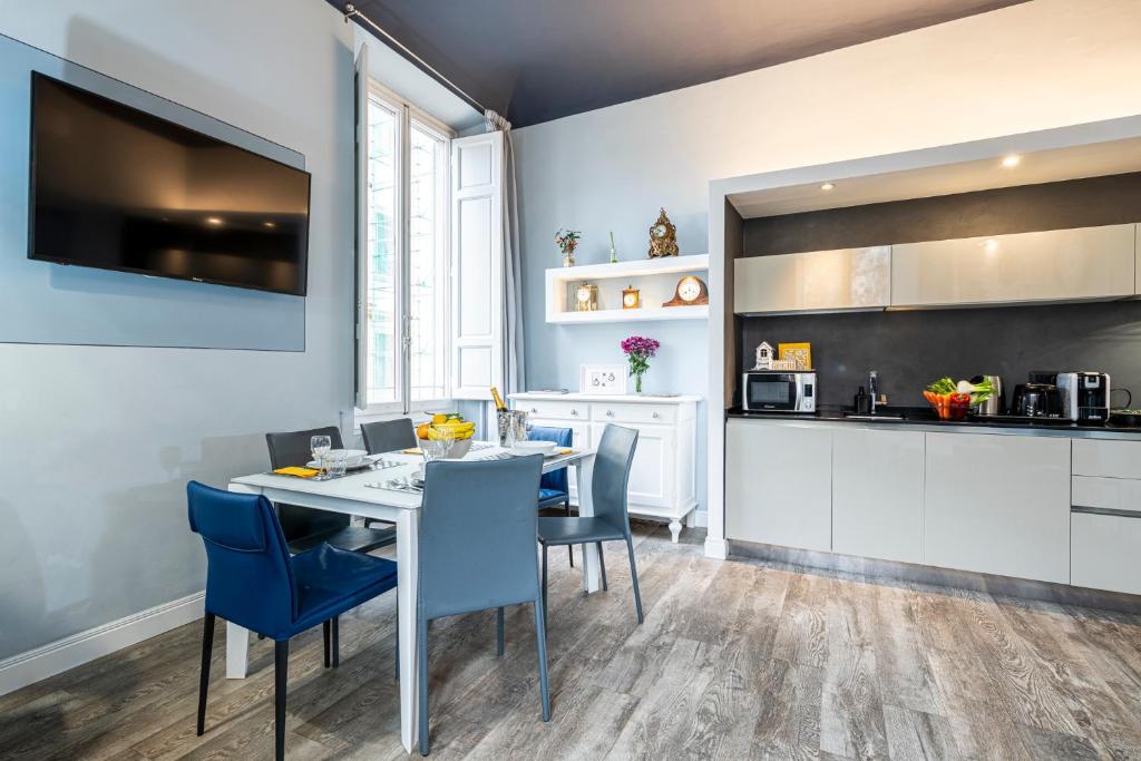 eine Küche und ein Esszimmer mit einem Tisch und Stühlen in der Unterkunft Cherubini Palace Thematic Apartment in Florenz