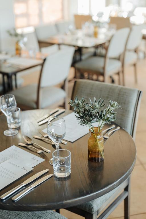 a wooden table with a vase of plants on it at Victoria in Holkham