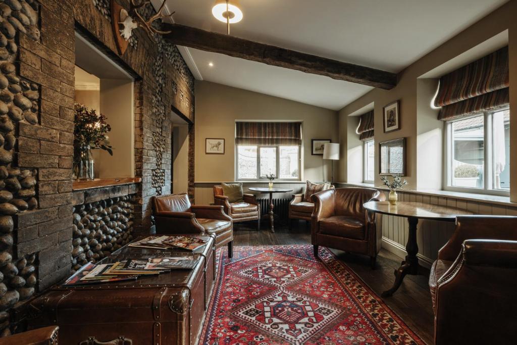 a living room with a table and chairs at Victoria in Holkham