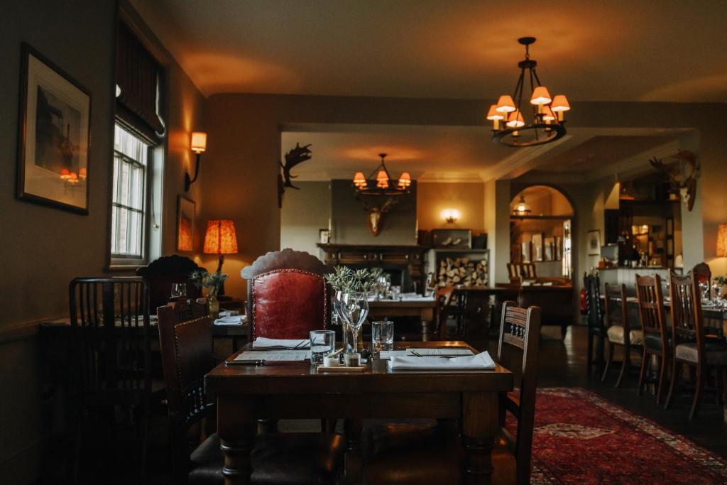 a dining room with a wooden table and chairs at Victoria in Holkham