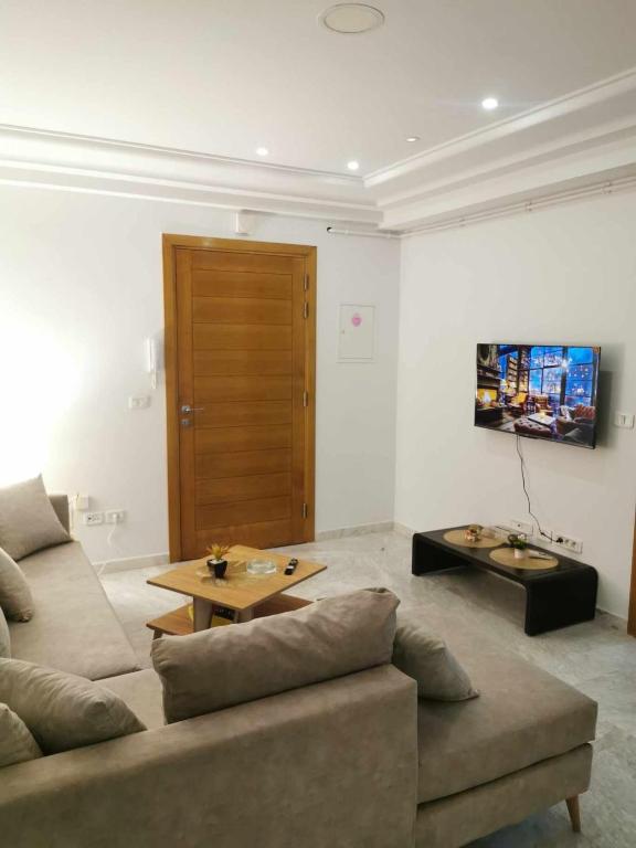 a living room with a couch and a table at Cosy Home in Carthage