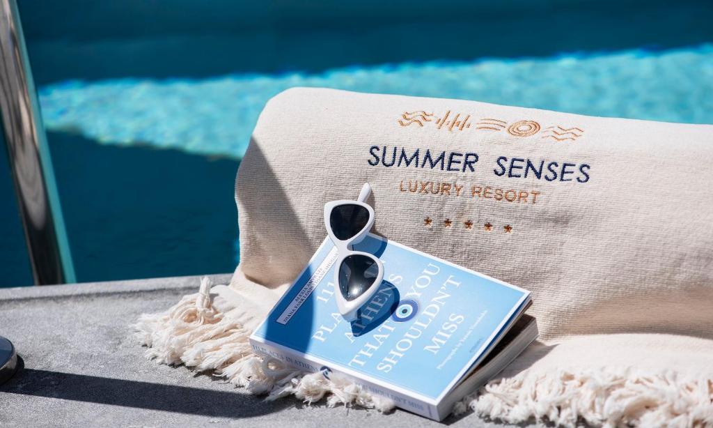 a pair of scissors sitting on top of a book at Summer Senses Luxury Resort in Logaras