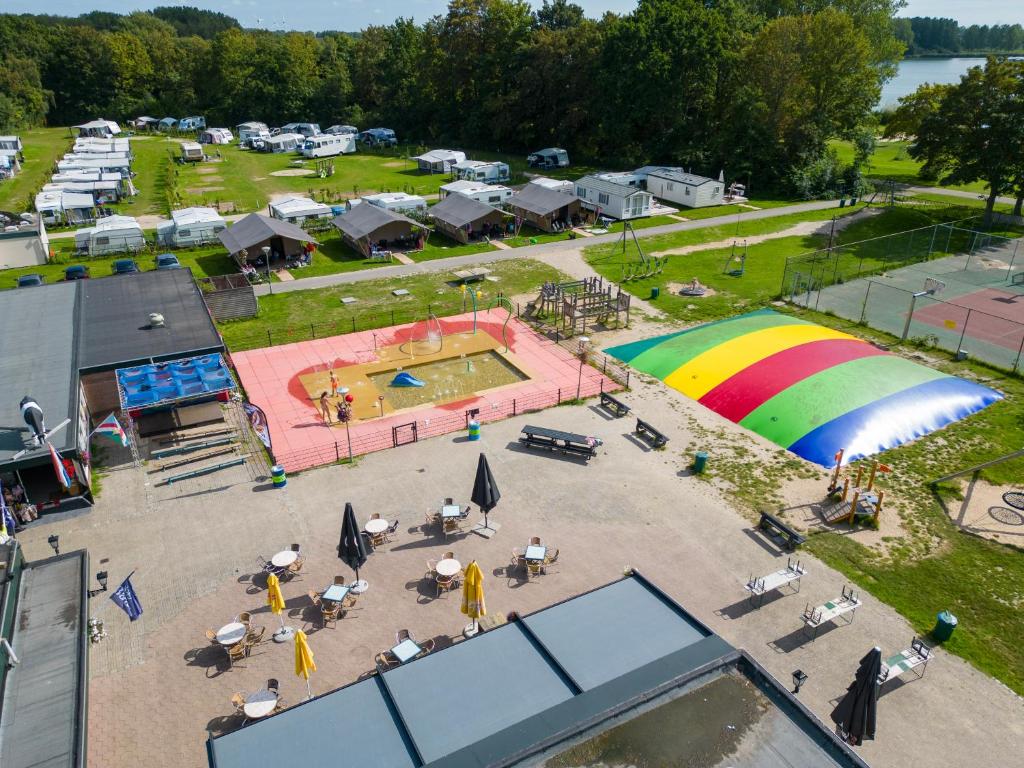 an aerial view of a park with a rainbow at Camping de Krabbeplaat in Brielle