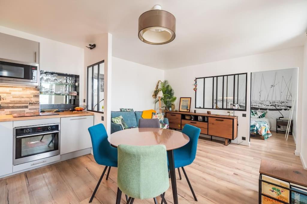 a kitchen and living room with a table and chairs at L'Escale Paimpolaise 2 Étoiles - centre historique in Paimpol