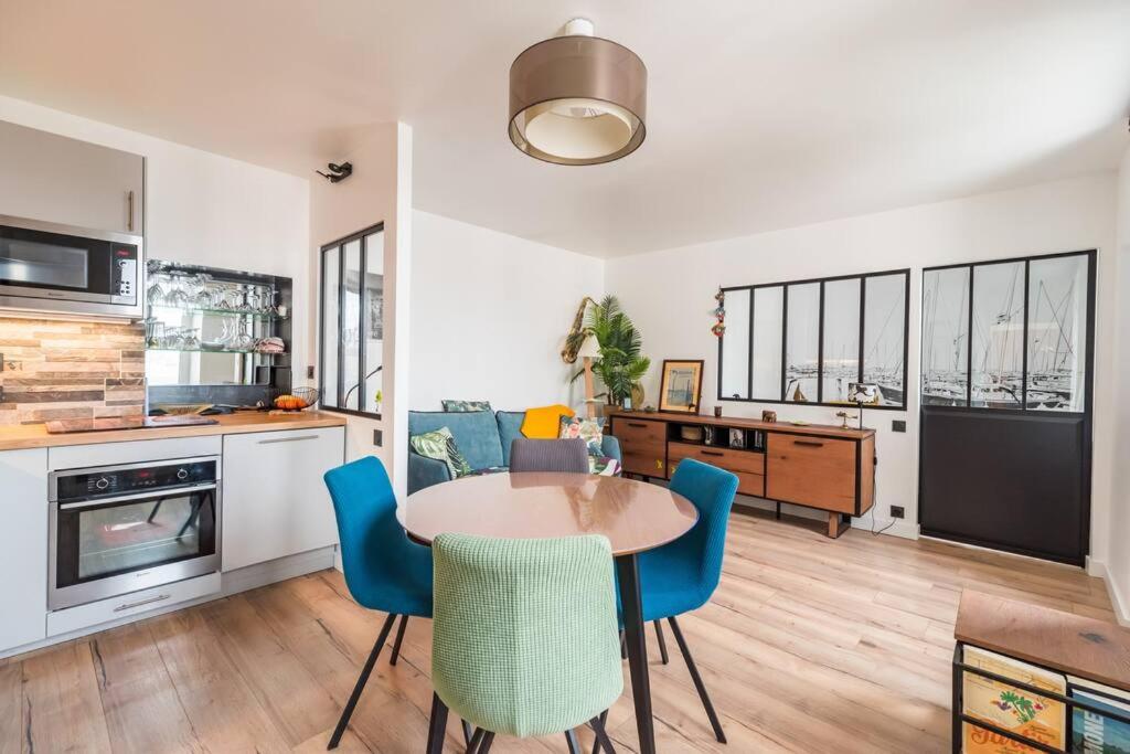 a kitchen and dining room with a table and chairs at L&#39;Escale Paimpolaise 2 Étoiles - centre historique in Paimpol