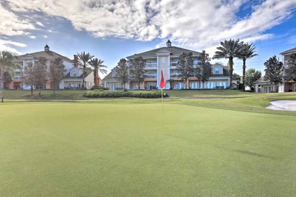 a golf course with a flag on a green at Luxury 3BR Reunion Resort Condo Near Disney Golf & Pools in Kissimmee