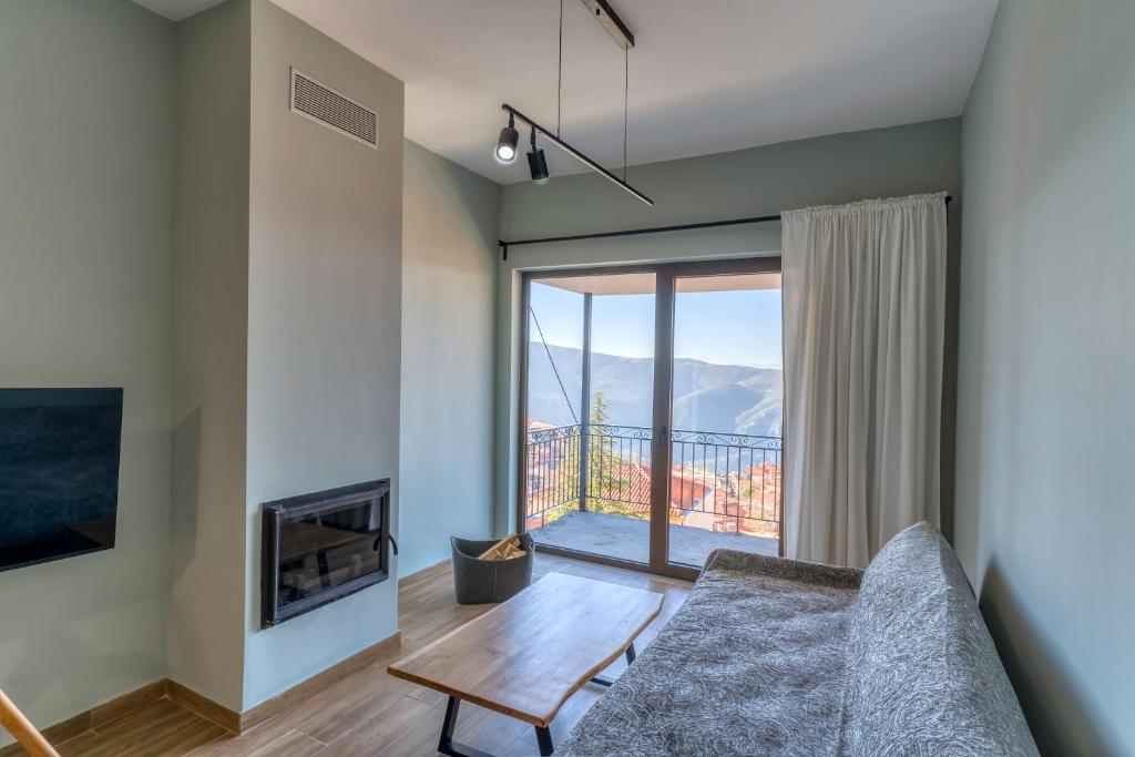 a living room with a couch and a fireplace at Arachova's Experience M2 in Arachova