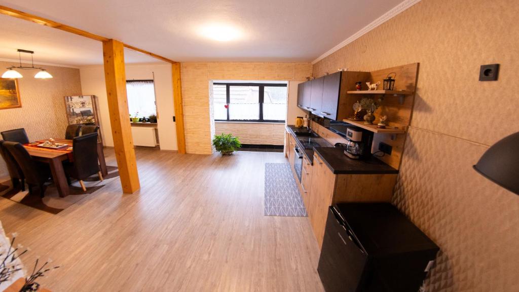 a living room with a kitchen and a dining room at may-homestay-saar in Neunkirchen