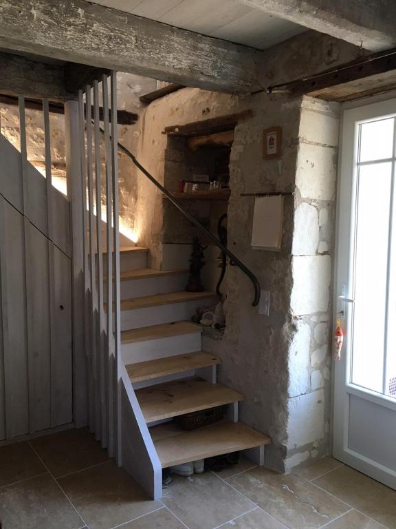 a set of stairs in a room with a door at Maison d hôtes Les Chantours dans réserve naturelle 15 hectares in Saint-Antoine-Cumond