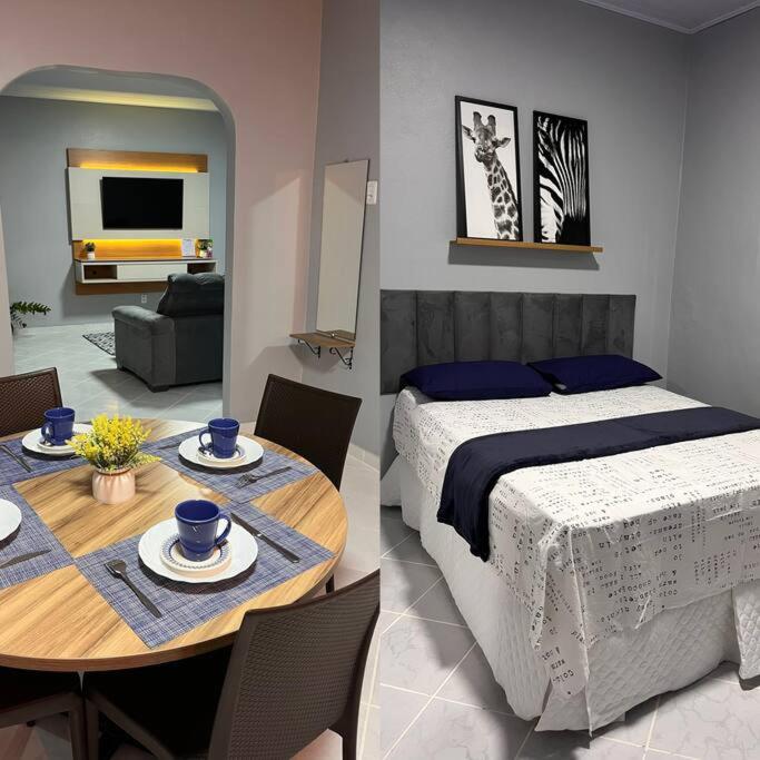 ein Schlafzimmer mit einem Bett und einem Tisch mit Tellern darauf in der Unterkunft Confortável APTO em Boa Vista. in Boa Vista