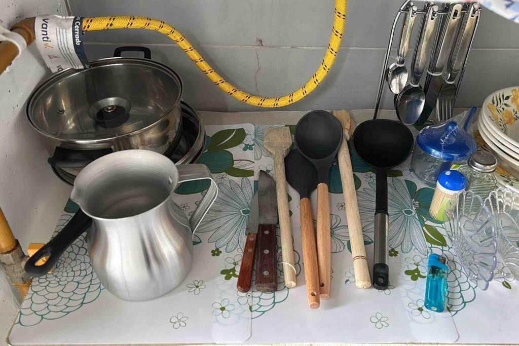 a kitchen counter with utensils on a counter top at Apartamento completo in Tocancipá