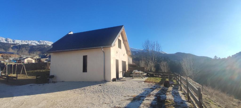 a small white building with a black roof at Chez Jo in Villard-de-Lans