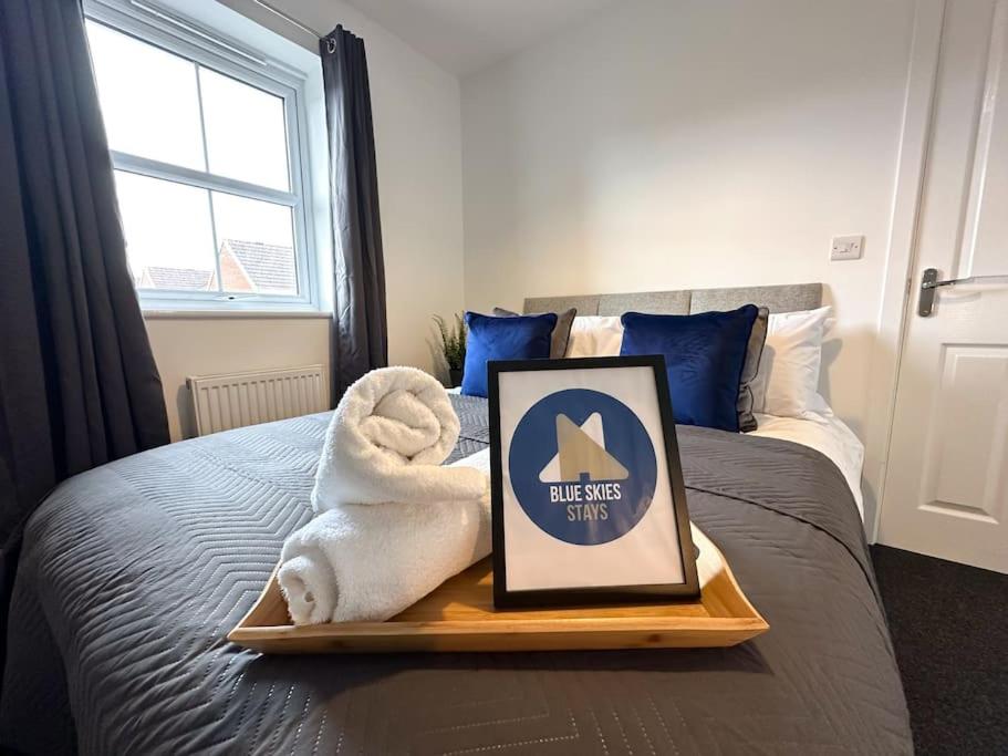 a tray with a towel on top of a bed at Densham House by Blue Skies Stays in Stockton-on-Tees