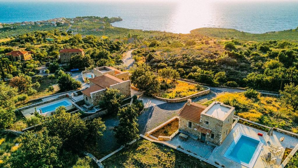 an aerial view of a house and the ocean at Gea Mani Villas in Agios Nikolaos