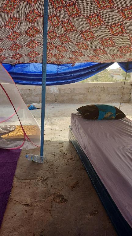 a bed in a room with a tent at transit in Nouakchott