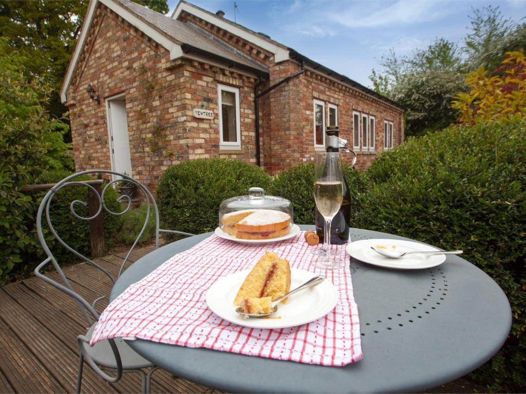 a table with a plate of cake on top of it at 1 Bed in Howden G0181 in Saltmarshe