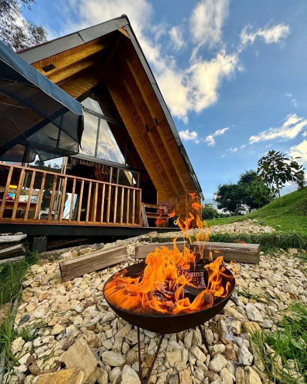 a fire pit in front of a house at Casa Índigo Tabio in Tabio