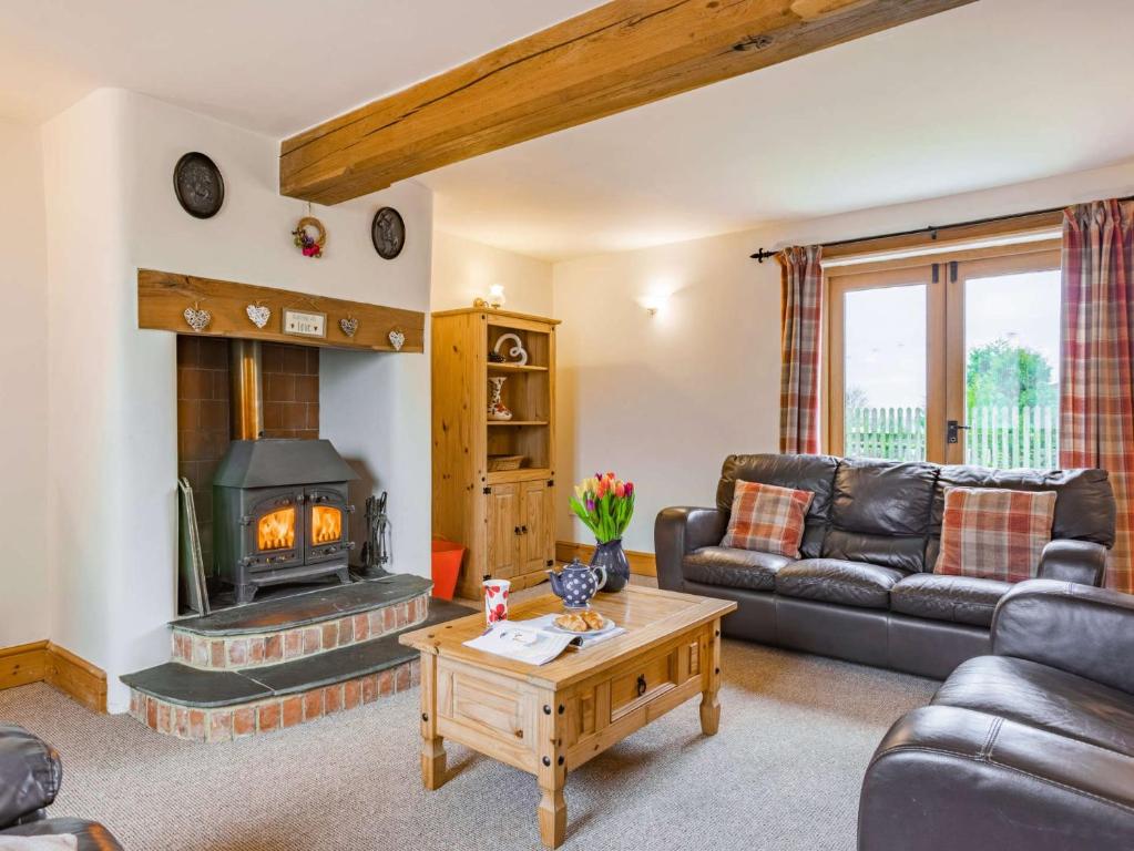 a living room with a couch and a fireplace at 4 Bed in High Bickington BCOUR in Burrington
