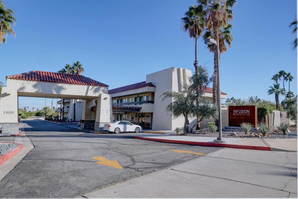 an empty parking lot in front of a hotel at The Infusion Beach Club in Palm Springs