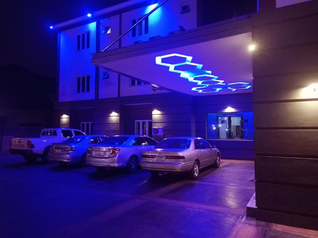 a group of cars parked in a parking lot at night at Merzino Palace in Uyo