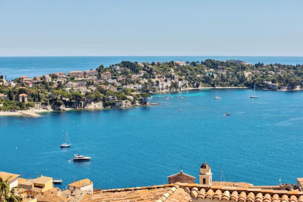a view of a large body of water with boats at VILLA BELLE VUE VI4394 By Riviera Holiday Homes in Villefranche-sur-Mer