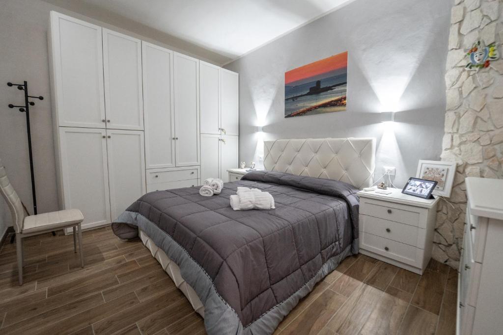 a bedroom with a large bed and a white cabinet at Casa Iraci La Nostra Sicilia in Trapani