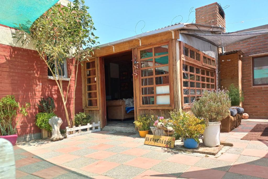 a house with a greenhouse with potted plants at Alojamiento Rural Polita, Agroturismo y Patrimonial in Petorca