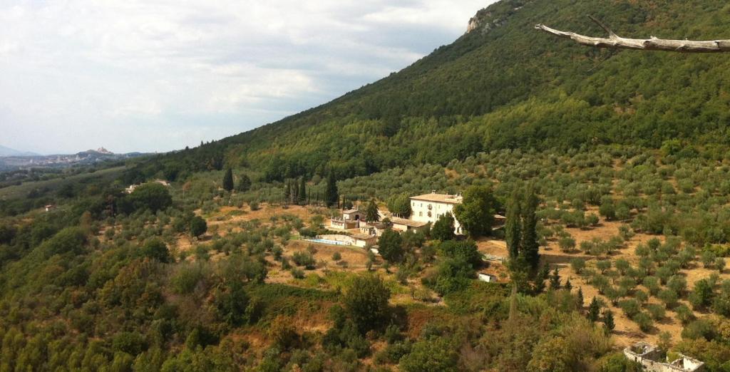 a view of a mountain with a house on a hill at Agriturismo Villa Gabbiano in Capodacqua