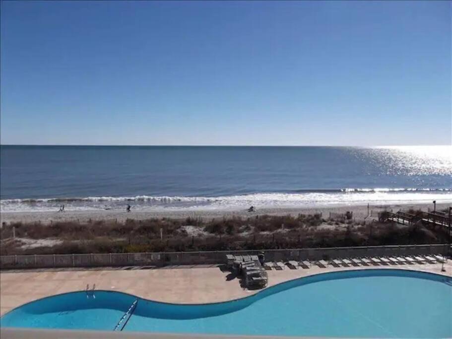 a view of the beach from the balcony at GRAND STRAND FUN WITH SO MUCH TO DO - EVEN PICKLEBALL! in Myrtle Beach