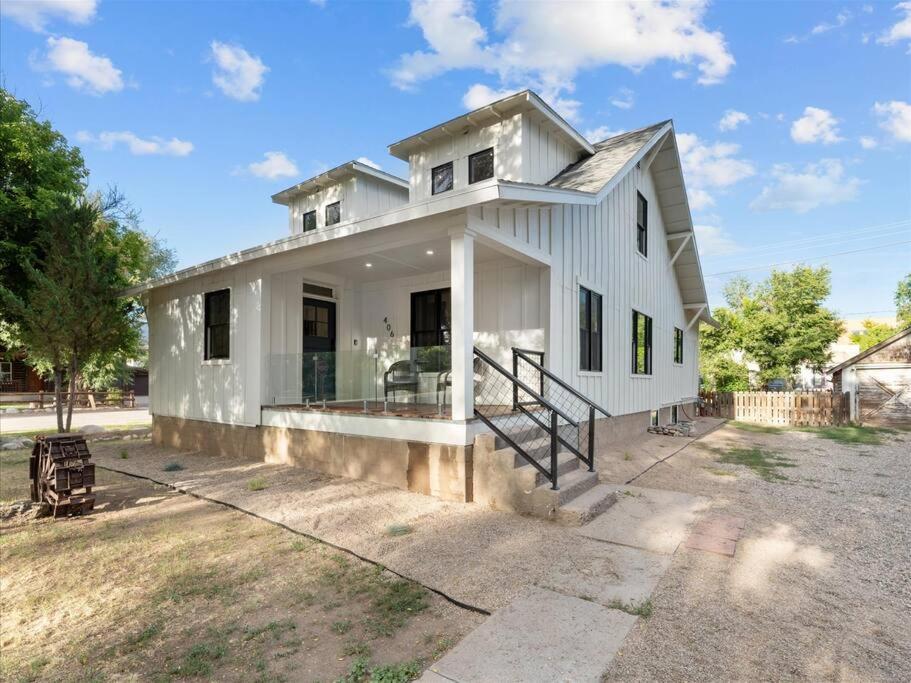 a white house with a driveway in front of it at Bike House in Eagle