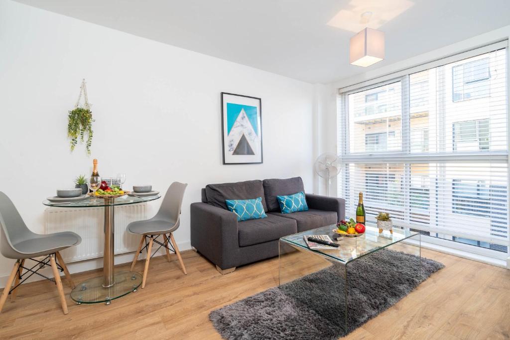 a living room with a couch and a table at Luxury Apartment - Private Parking - City Centre - Free Netflix & Wifi - 304H in Birmingham